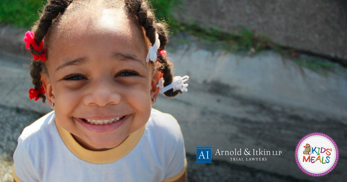 A Kids' Meal Inc. child smiling at the camera. A Kids' Meal Inc. child smiling at the camera.